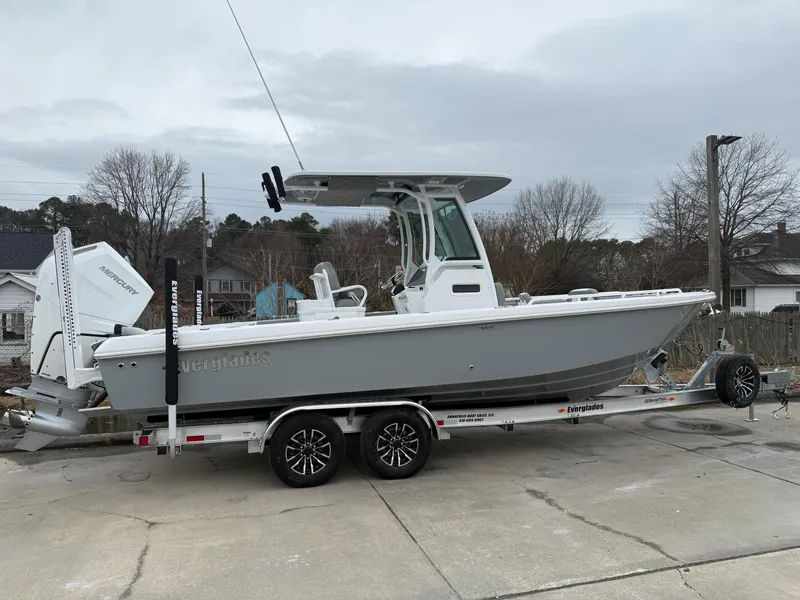 The Image of 2025 Everglades 253 Center Console boat on trailer, parked outdoors. - 0