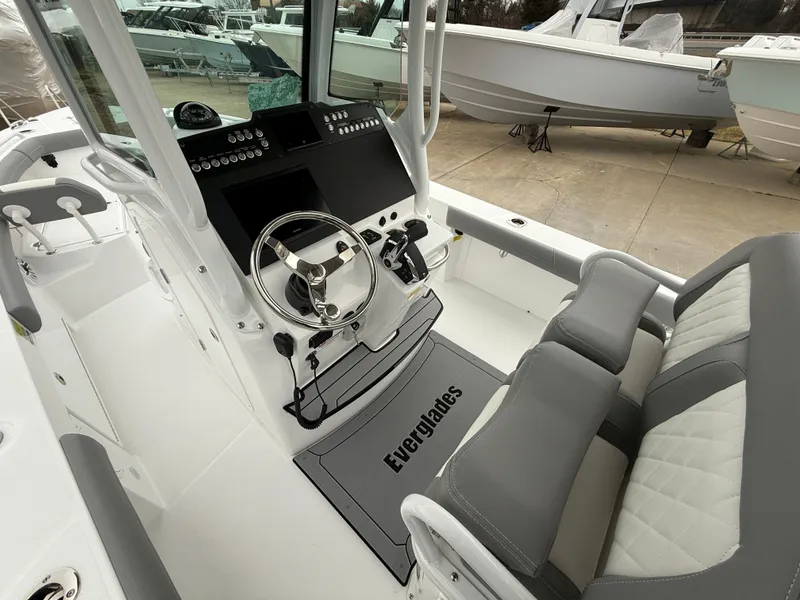 Slide: The Image of 2025 Everglades 253 Center Console boat interior with steering wheel and seating. - 14