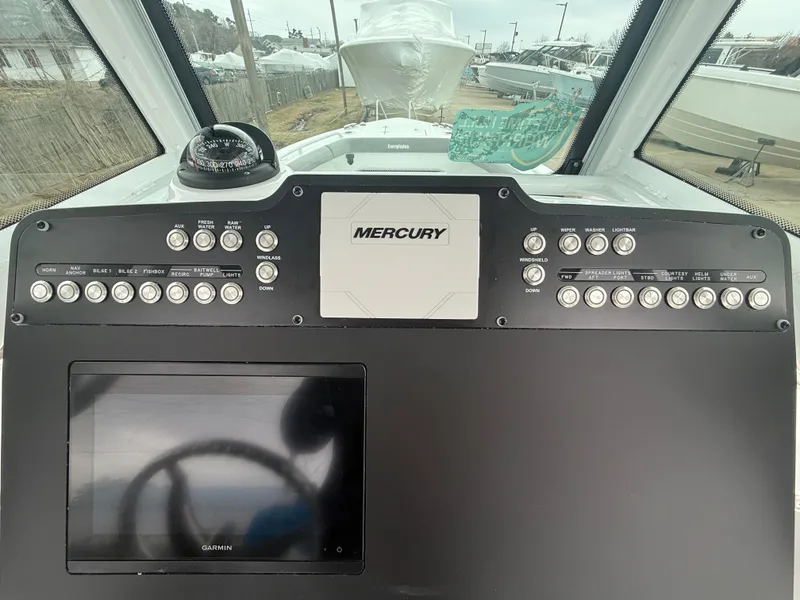 Slide: The Image of Dashboard of 2025 Everglades 253 Center Console boat with Mercury controls. - 17