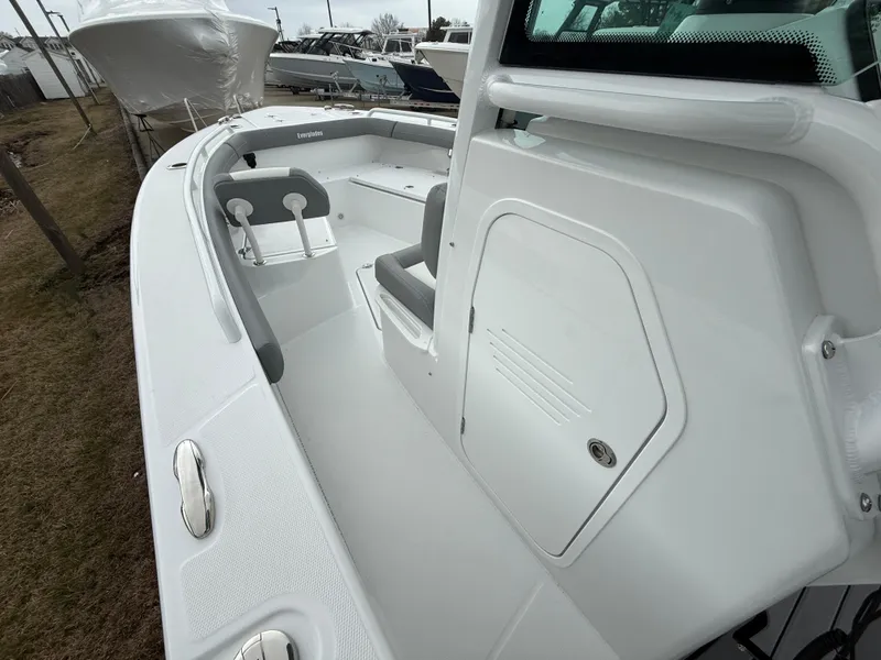 Slide: The Image of 2025 Everglades 253 Center Console boat interior, showcasing seating and storage features. - 19