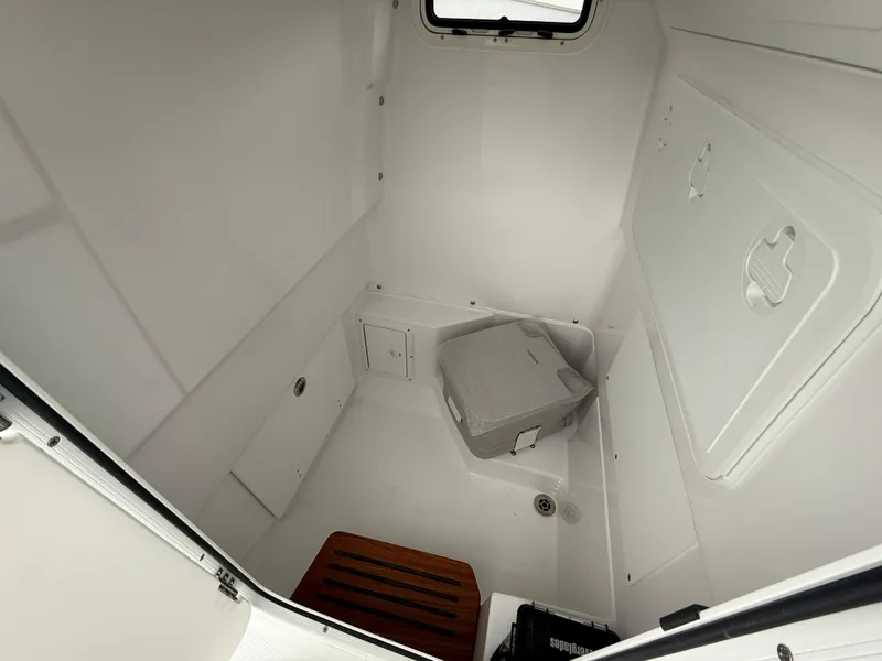 Slide: The Image of Interior of 2025 Everglades 253 Center Console boat, featuring a compact cabin space. - 20