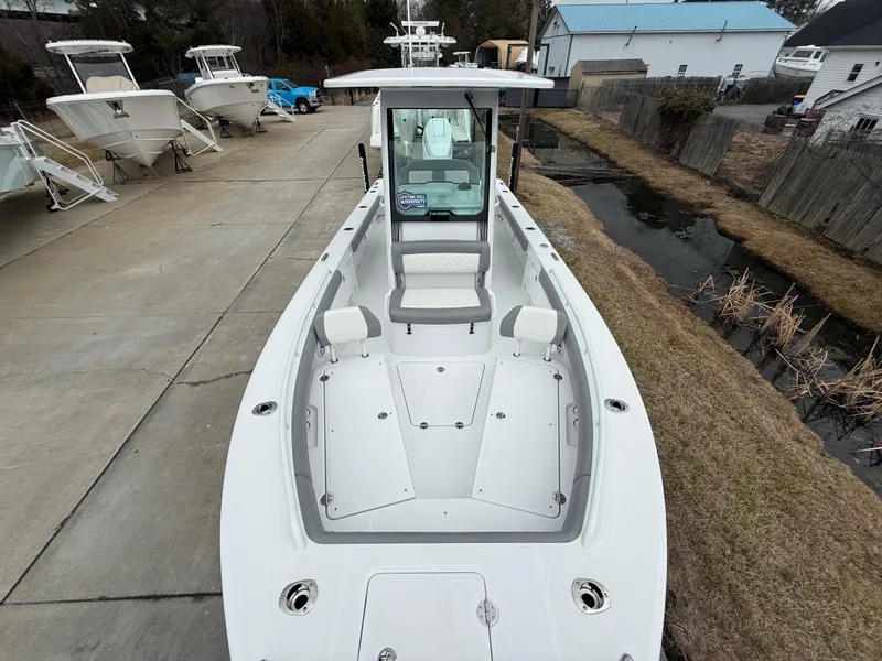 Slide: The Image of 2025 Everglades 253 Center Console boat on display in a marina setting. - 26