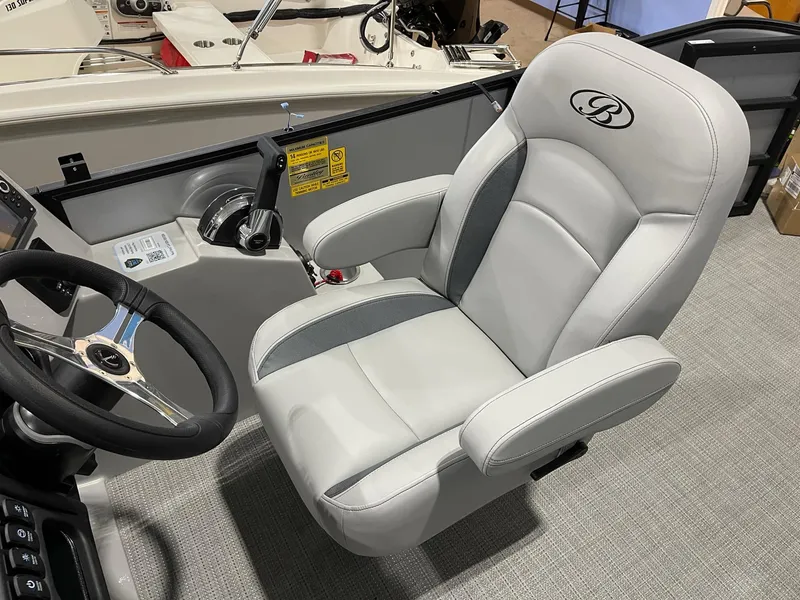 Slide: The Image of 2025 Bentley Pontoons Legacy 200 Cruise XL captain's chair, luxurious design with steering wheel. - 10