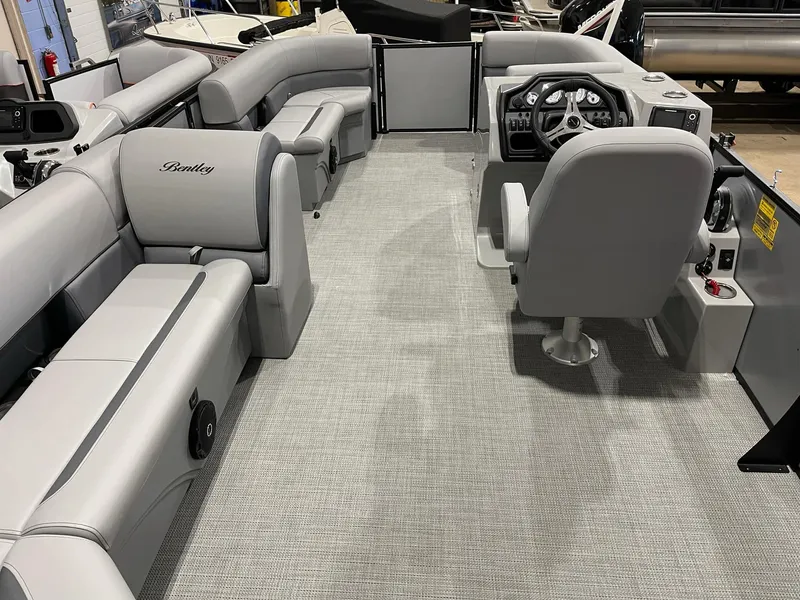 Slide: The Image of 2025 Bentley Pontoons Legacy 200 Cruise XL interior with spacious seating and modern helm. - 12