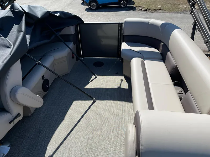Slide: The Image of 2025 Bentley Pontoons LE 200 CW interior with beige seating and open deck. - 11