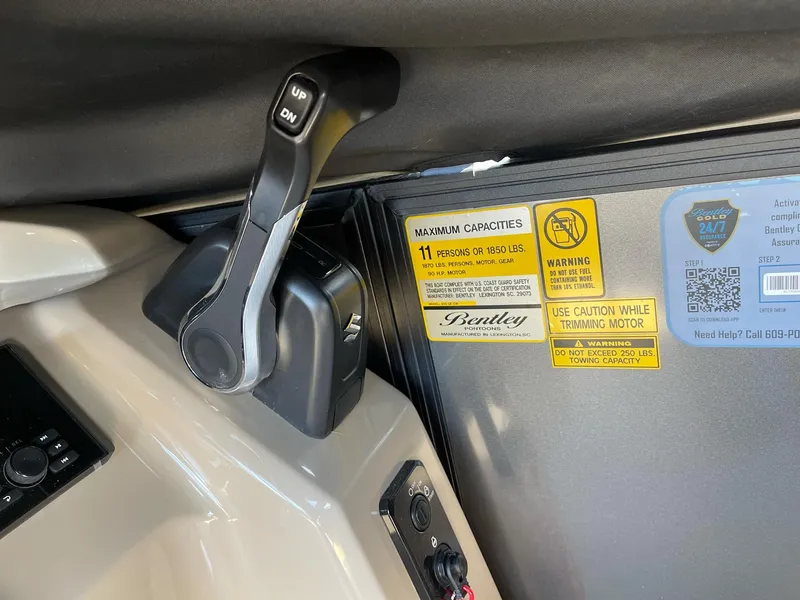 Slide: The Image of 2025 Bentley Pontoons LE 200 CW control panel with capacity and warning labels. - 13
