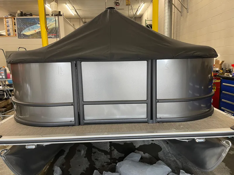 Slide: The Image of 2025 Bentley Pontoons LE 200 CW with cover in a workshop setting. - 4