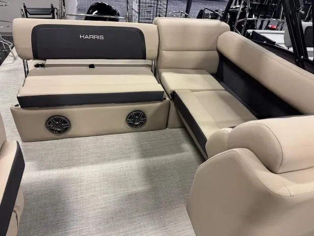 Slide: The Image of 2025 Harris Cruiser 210 interior with beige seating and built-in speakers. - 3