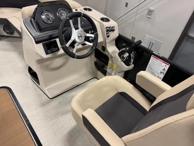 Slide: The Image of 2025 Harris Cruiser 210 boat interior with steering wheel and control panel. - 4