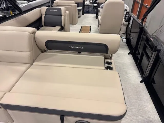 Slide: The Image of 2025 Harris Cruiser 210 interior with beige seating and cup holders. - 5