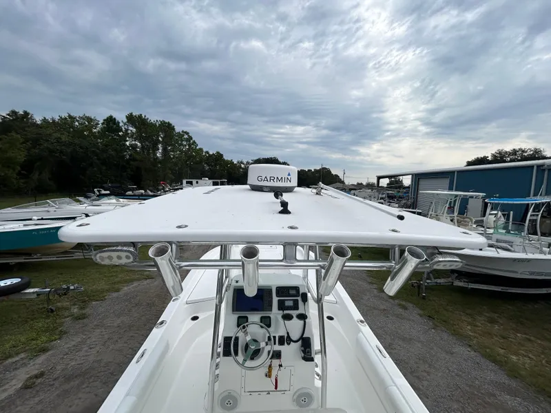 Slide: The Image of 2012 SeaHunter 24 Bay boat with Garmin equipment, docked under a cloudy sky. - 14