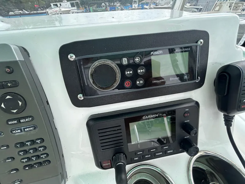 Slide: The Image of Control panel of a 2012 SeaHunter 24 Bay boat with Fusion and Garmin devices. - 15
