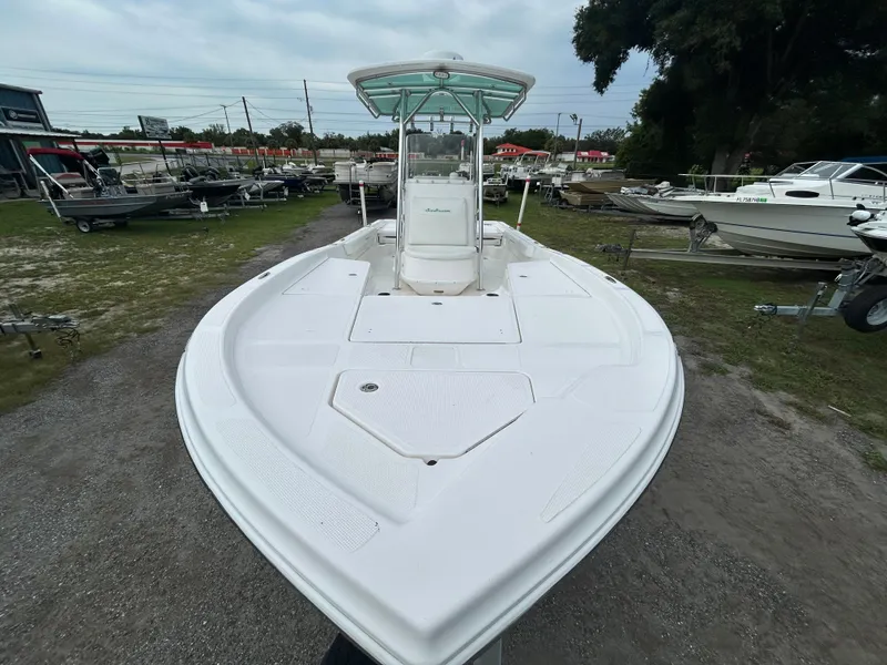 Slide: The Image of 2012 SeaHunter 24 Bay boat on display, featuring a spacious deck and center console. - 6