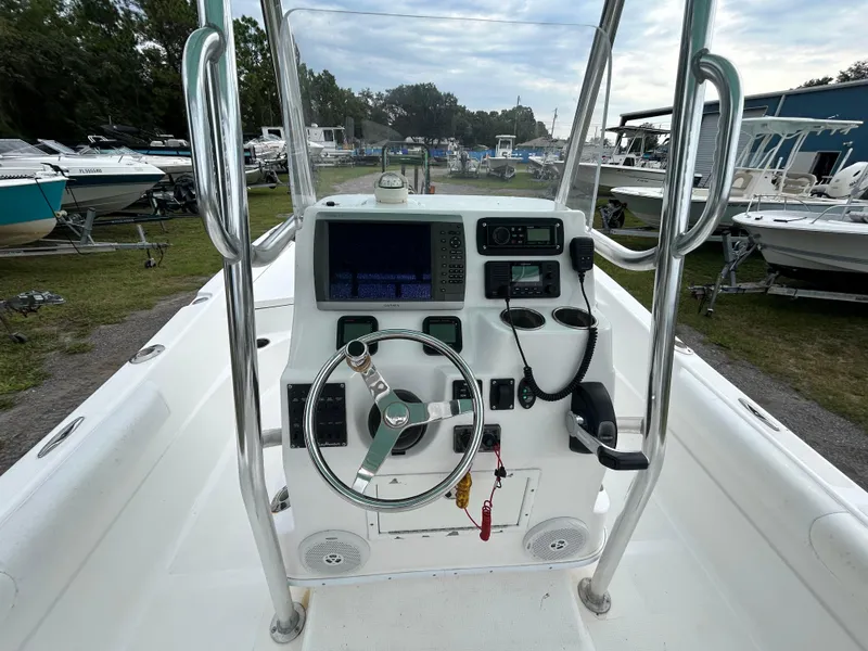 Slide: The Image of 2012 SeaHunter 24 Bay boat console with steering wheel and navigation equipment. - 9