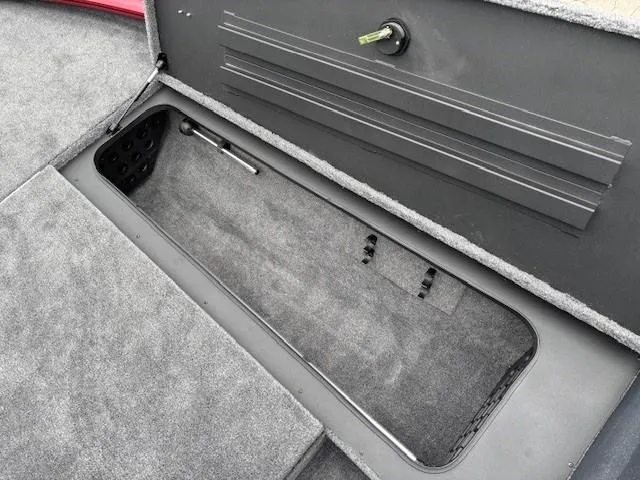 Slide: The Image of 2025 Tracker Savage 215 boat deck with gray carpet and storage compartments. - 10