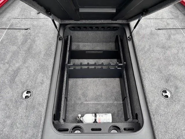 Slide: The Image of Open storage compartment in 2025 Tracker Savage 215 boat, featuring a secure lock mechanism. - 13