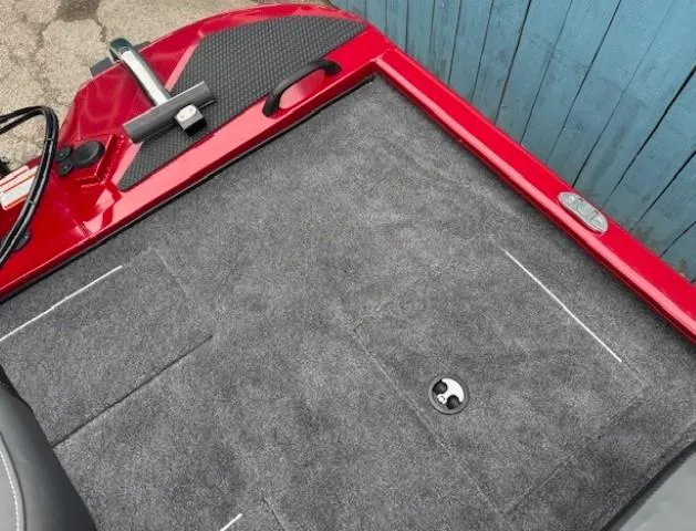 Slide: The Image of 2025 Tracker Savage 215 boat seat with gray and red upholstery, set against a blue background. - 25