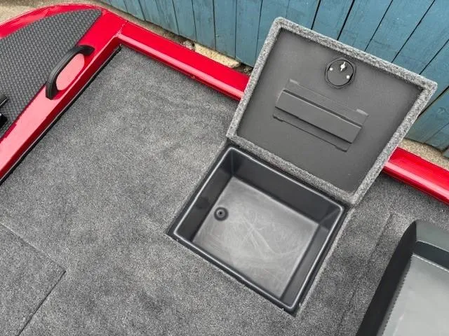 Slide: The Image of 2025 Tracker Savage 215 boat storage compartment with dual lids and blue interior. - 26