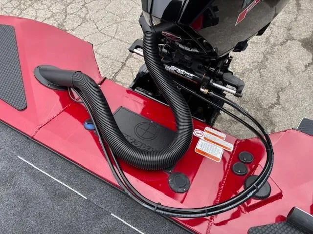 Slide: The Image of Open storage compartment on 2025 Tracker Savage 215 boat with gray carpeted deck. - 28