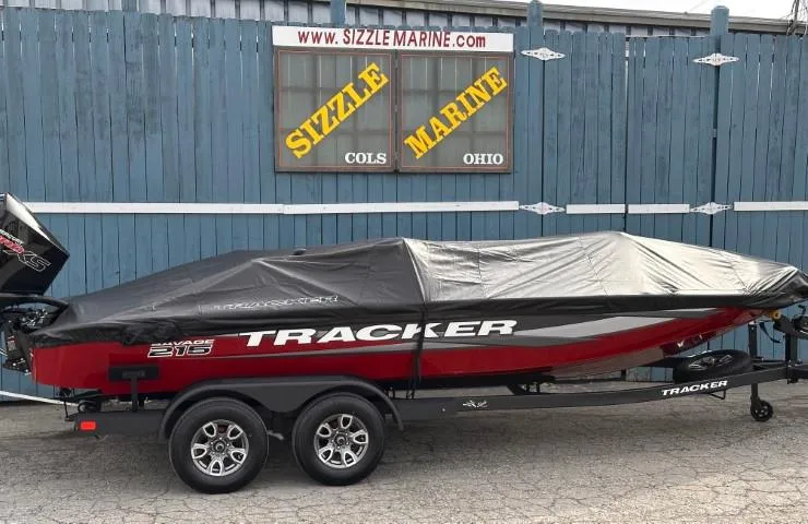 Slide: The Image of 2025 Tracker Savage 215 boat engine area with red detailing and black tubing. - 30