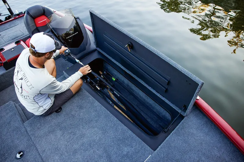 Slide: The Image of 2025 Tracker Savage 215 boat with Mercury engine, black and red design. - 31