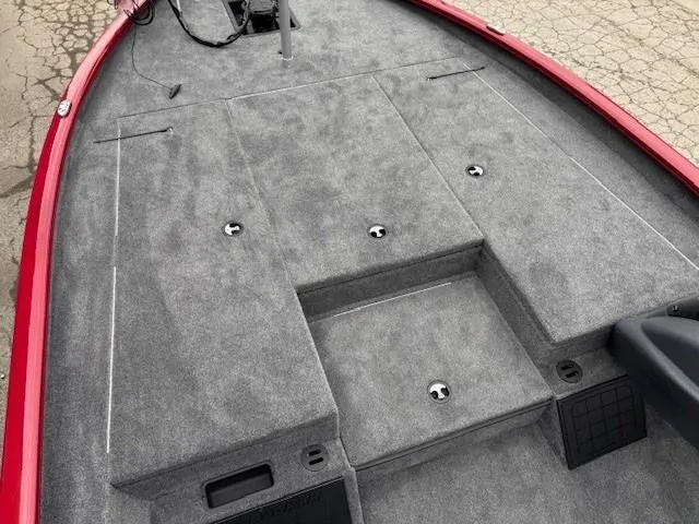 Slide: The Image of 2025 Tracker Savage 215 boat deck with gray carpet and red trim. - 9