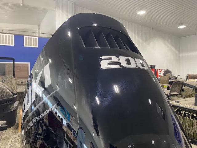 Slide: The Image of 2025 SeaArk Protege with Suzuki 200 outboard engine in a showroom. - 10