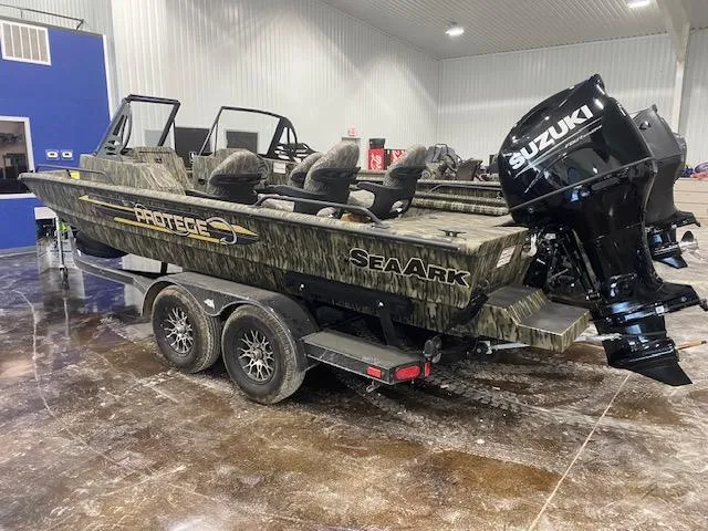 Slide: The Image of 2025 SeaArk Protege boat with Suzuki engine in indoor showroom. - 2