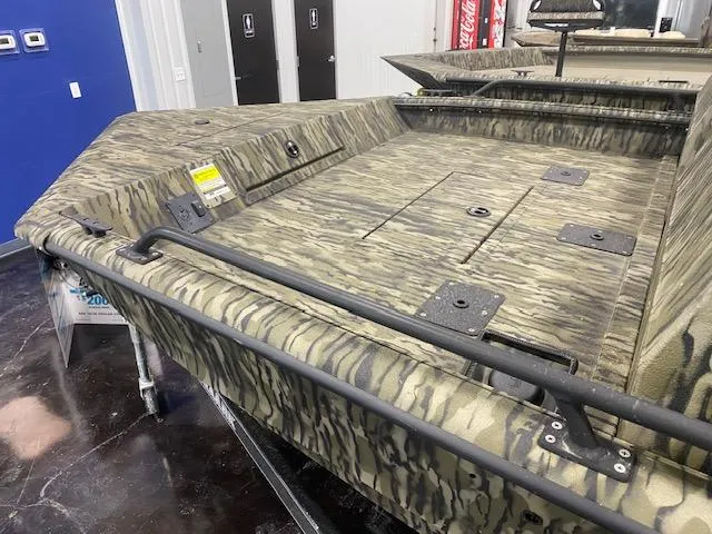 Slide: The Image of 2025 SeaArk Protege boat with camouflage design, displayed indoors. - 4