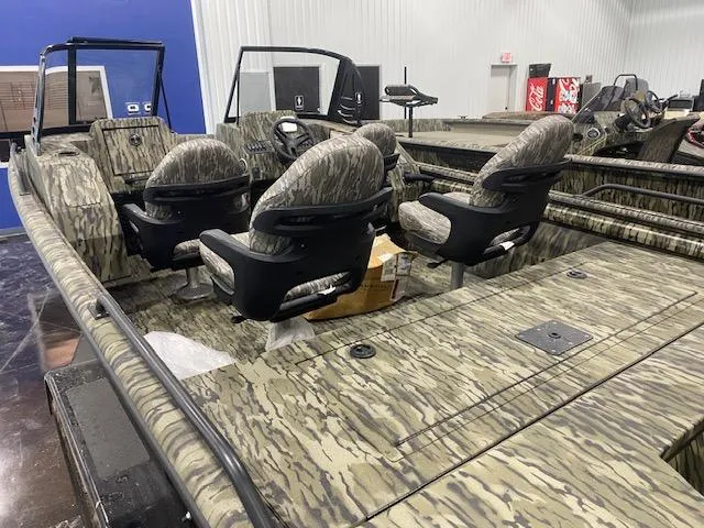 Slide: The Image of 2025 SeaArk Protege boat interior with camouflage seating and spacious layout. - 5