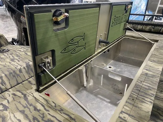 Slide: The Image of 2025 SeaArk Protege boat with open storage compartment, featuring fish graphics and camouflage design. - 9