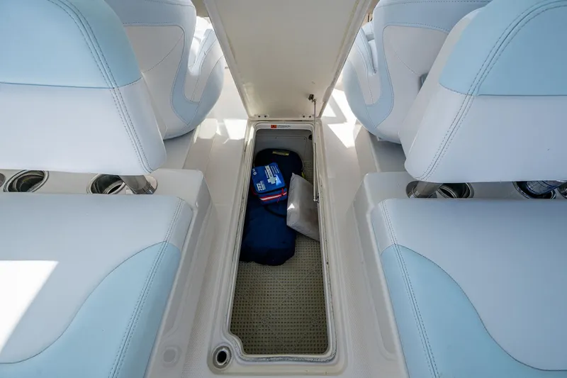 Slide: The Image of 2019 Robalo R317 Dual Console boat interior storage compartment with items inside. - 22