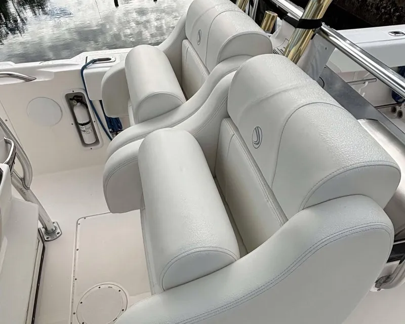 Slide: The Image of 2012 Edgewater 318CC boat with white leather seating and polished metal accents. - 11