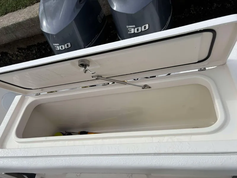 Slide: The Image of Open storage compartment on 2012 Edgewater 318CC boat with Yamaha 300 engines. - 14
