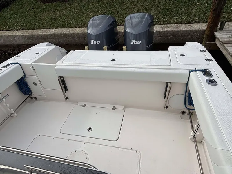 Slide: The Image of 2012 Edgewater 318CC boat with twin 300 horsepower engines, spacious deck layout. - 16