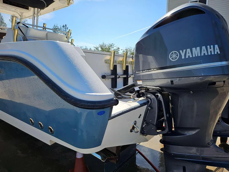 Slide: The Image of 2012 Edgewater 318CC boat with Yamaha outboard motor, docked outdoors. - 18