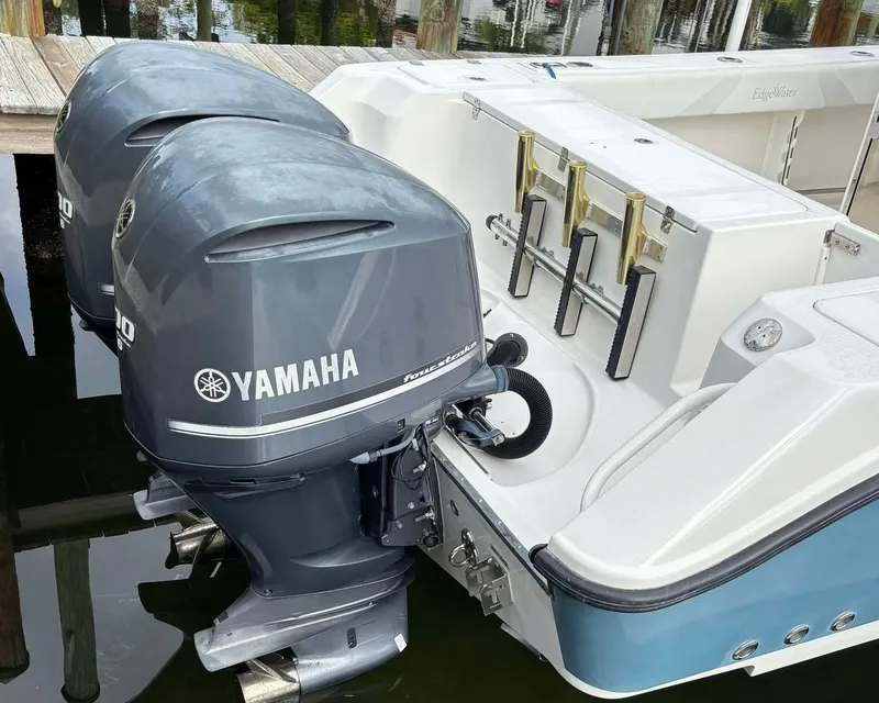 Slide: The Image of 2012 Edgewater 318CC boat with dual Yamaha outboard motors docked. - 19