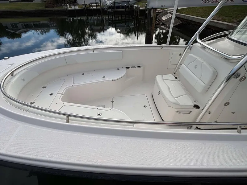 Slide: The Image of 2012 Edgewater 318CC boat interior with white seating and storage compartments. - 5