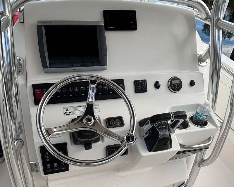 Slide: The Image of 2012 Edgewater 318CC boat dashboard with steering wheel and navigation controls. - 8