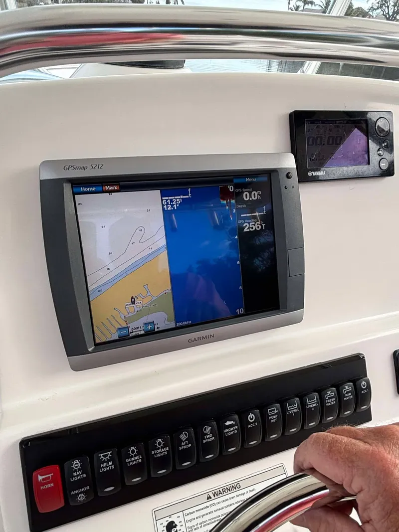 Slide: The Image of Control panel of a 2012 Edgewater 318CC boat with navigation display. - 9