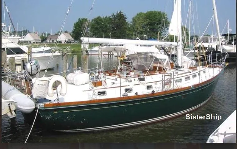 The Image of Sailboat docked in marina, 1990 Bristol 47.7 model, green hull, white deck. - 0