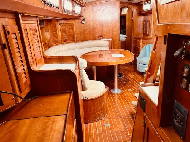Slide: The Image of Interior of a 1990 Bristol 47.7 yacht with wooden furnishings and cozy seating area. - 16