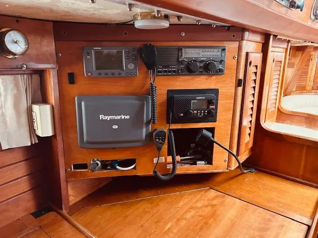 Slide: The Image of 1990 Bristol 47.7 yacht navigation panel with Raymarine equipment and communication devices. - 17