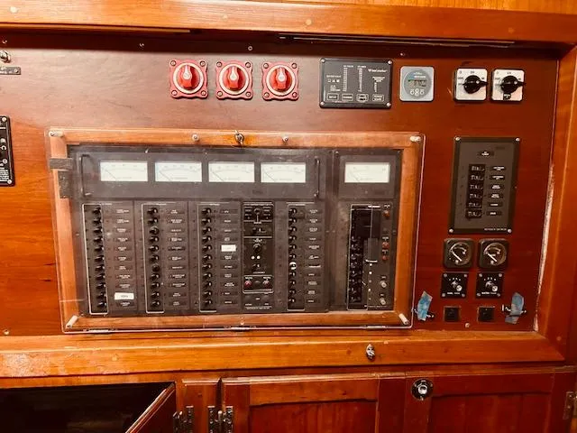 Slide: The Image of Electrical control panel on a 1990 Bristol 47.7 yacht, featuring gauges and switches. - 18