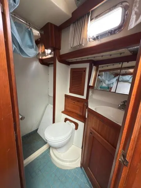 Slide: The Image of 1990 Bristol 47.7 yacht bathroom with wooden cabinetry and compact design. - 23