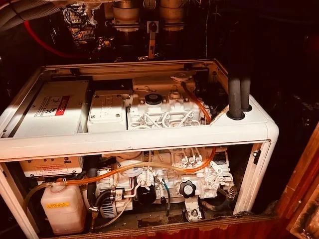 Slide: The Image of Engine compartment of a 1990 Bristol 47.7 yacht, showcasing mechanical components and wiring. - 26