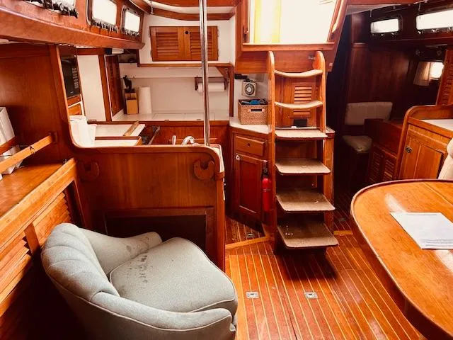 Slide: The Image of Interior of 1990 Bristol 47.7 yacht with wooden finishes and cozy seating. - 5