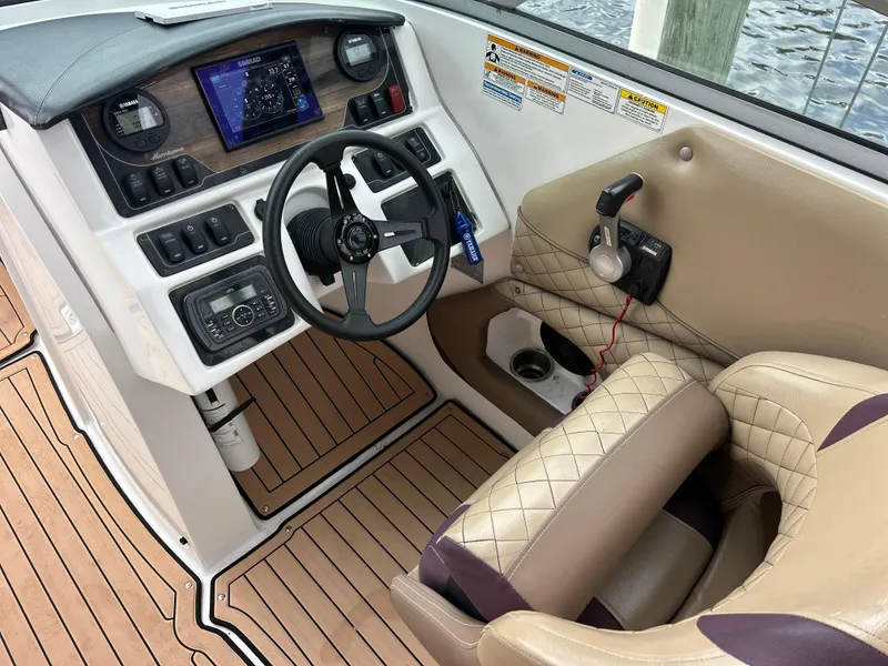 Slide: The Image of 2019 Hurricane SunDeck 2690 OB boat cockpit with steering wheel and control panel. - 28