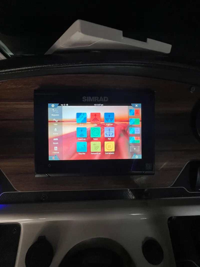 Slide: The Image of Simrad display on 2019 Hurricane SunDeck 2690 OB boat dashboard, showing navigation interface. - 30