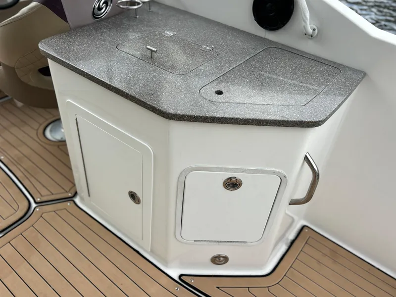 Slide: The Image of 2019 Hurricane SunDeck 2690 OB boat interior with sleek countertop and storage cabinets. - 32
